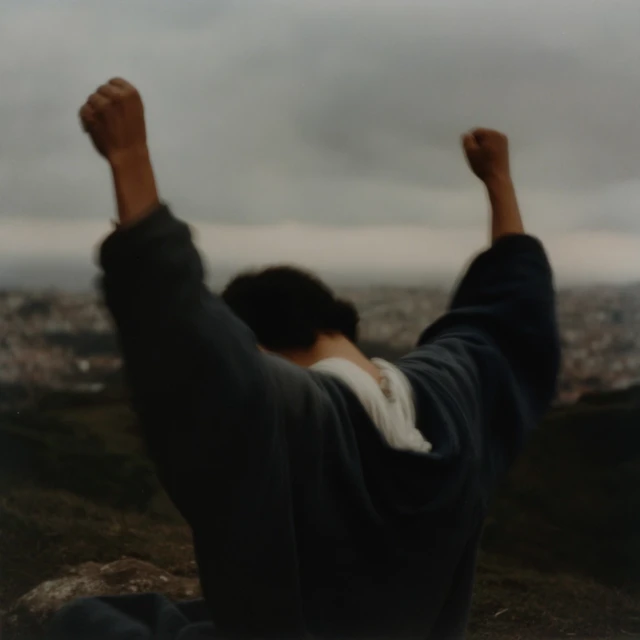 Hispanic Man Silhouetted Praying at Sunset