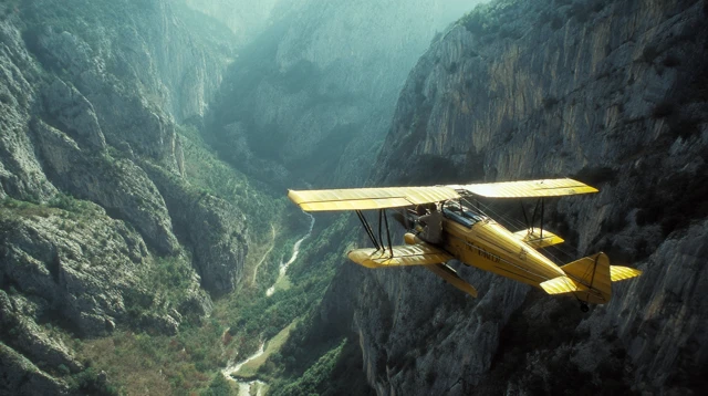 Yellow Biplane Flying Over Valley Canon Film 4K