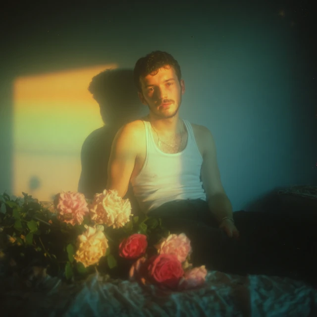 Man with Roses Blue Nighttime Photograph