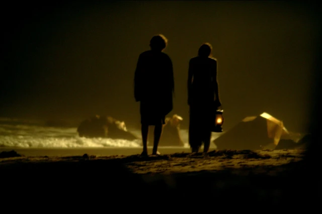 Night Beach Scene with Oil Lamps