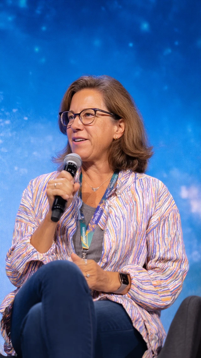 Woman Speaking on Stage at Conference