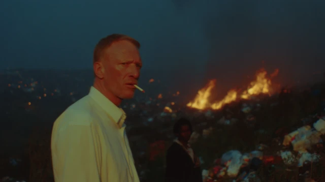 Middle Aged Man Smoking Amidst Flames