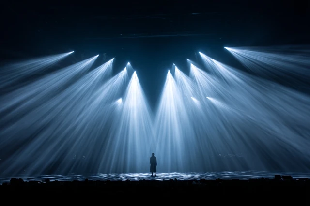 Stage Spotlight A Person Illuminated by Light Beams