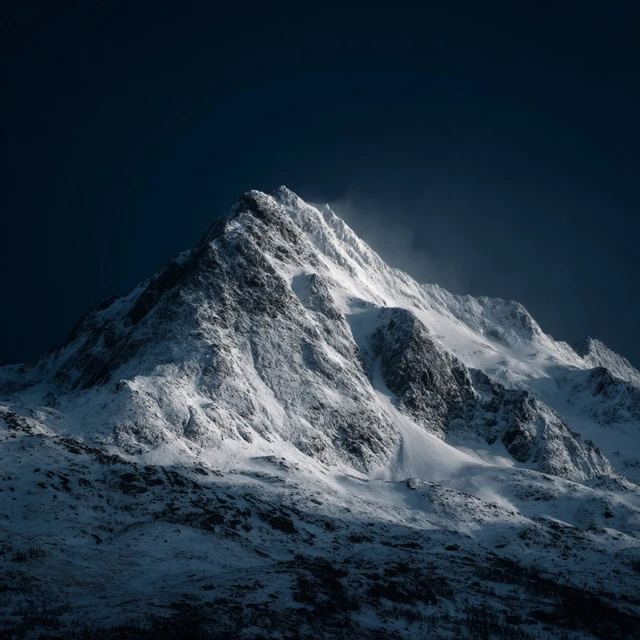 Snowy Mountain Peak Under a Dark Sky