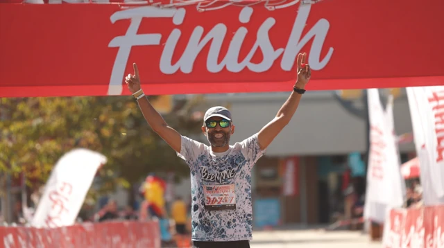 Runner Crossing Finish Line Triumphantly