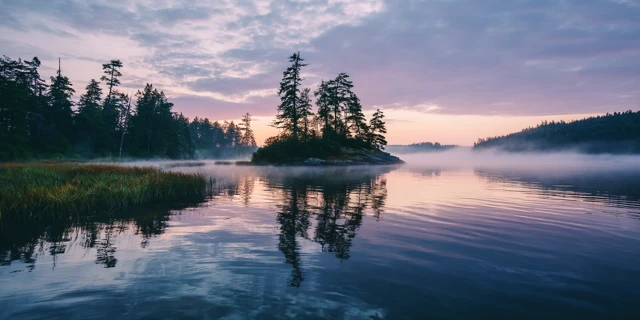 Serene Lake at Dawn Reflecting Pastel Sky