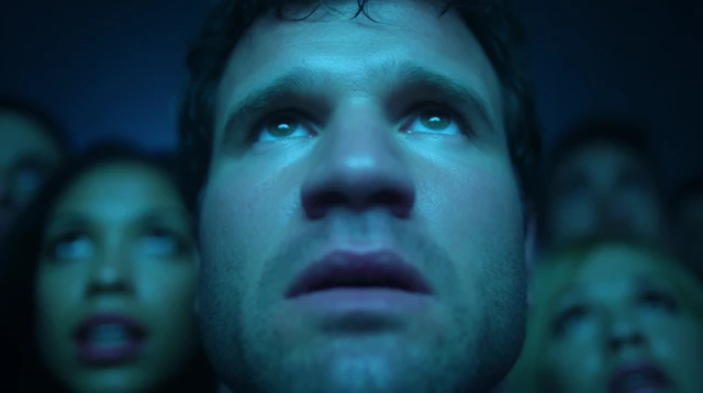 Man with Intense Gaze under Blue Emergency Light