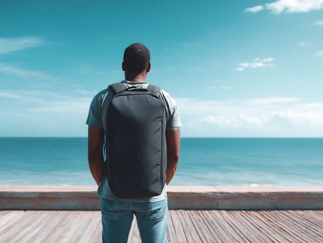 Man on Beach with Backpack Ocean View