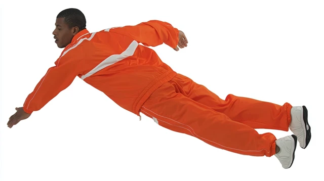 Man in Orange Sportswear Falling in Free Fall
