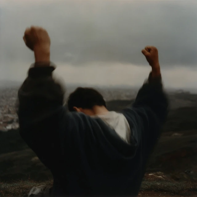 Hispanic Man Silhouetted Praying at Sunset
