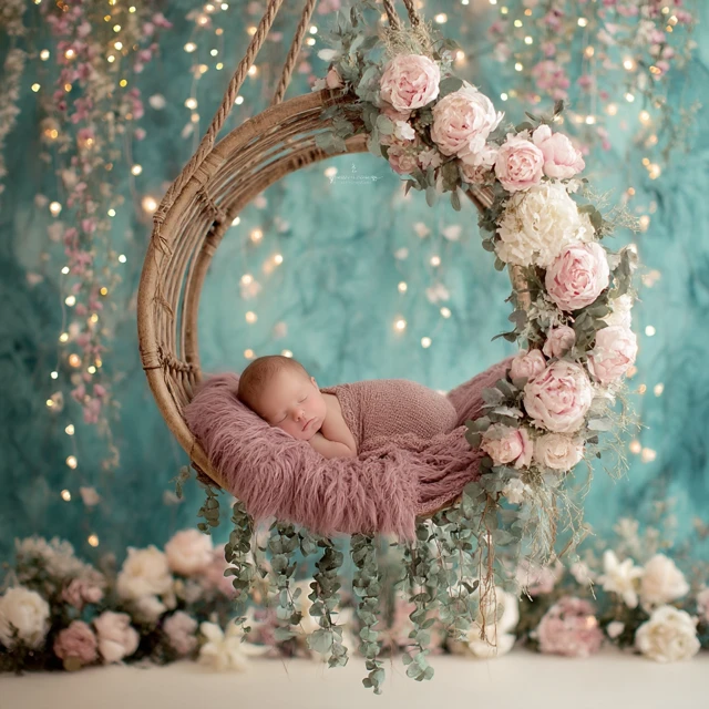 Newborn Baby Sleeping in Floral Swing Portrait