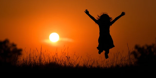 Joyful Child Embracing the Sunshine Concept Stock Photo