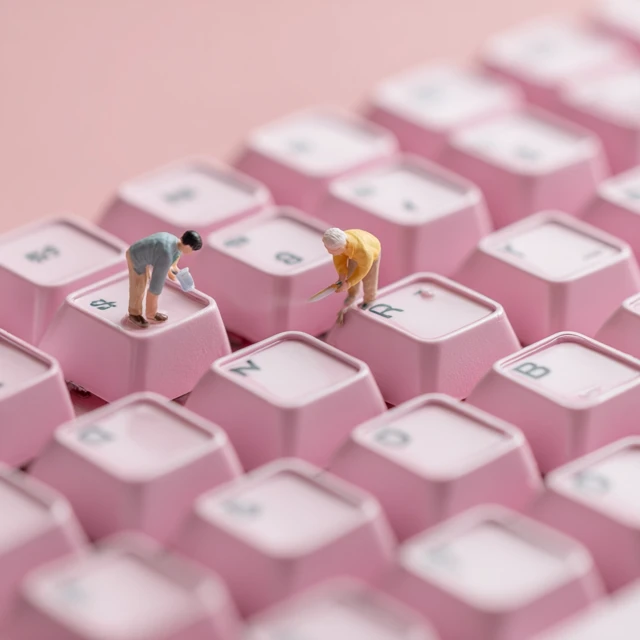 Miniature People on a Pink Keyboard