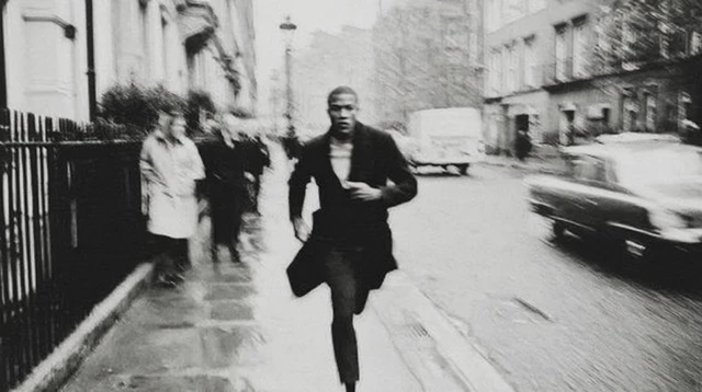 Man Running Down Street Black and White Photography