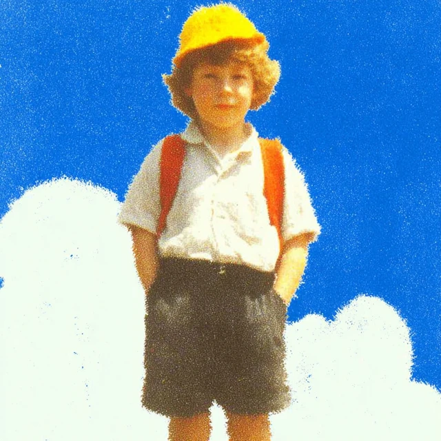 Child in School Uniform with Yellow Hat and Backpack