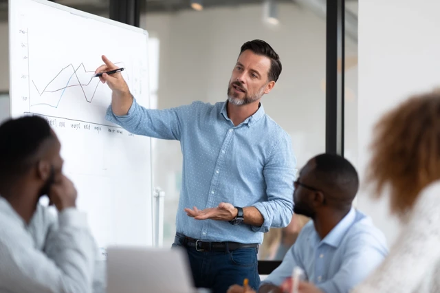 Business Presentation Man Pointing At Graph