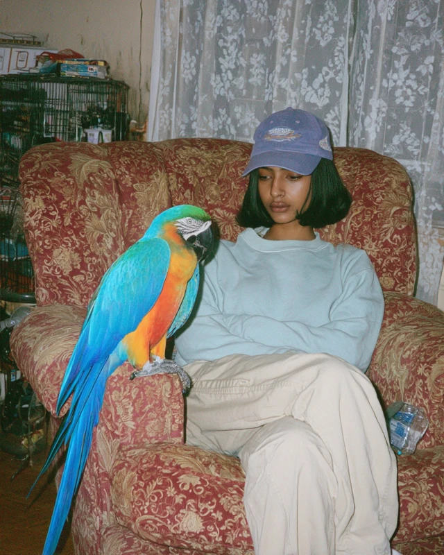 Woman in Cap with Parrot iPhone 14 Photo