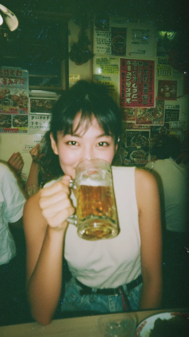 Young Japanese Woman Enjoying Beer at Retro Diner