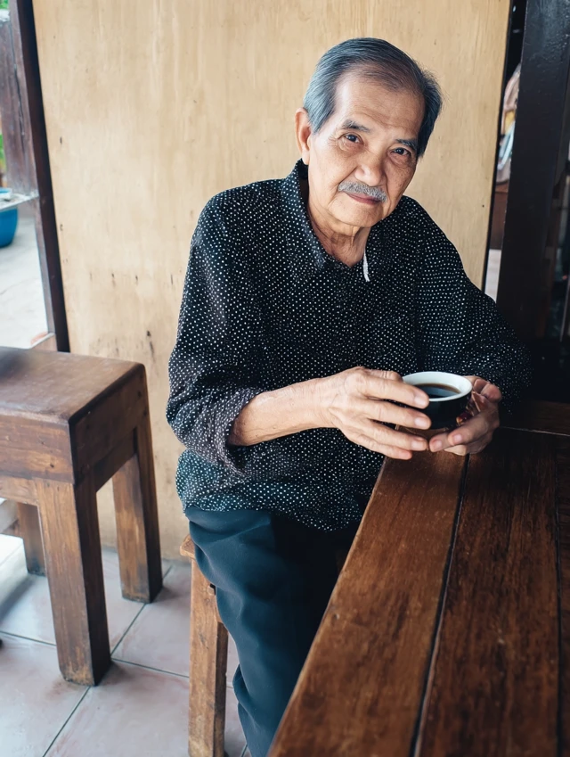 Cute Grandfather Relaxing with Tea