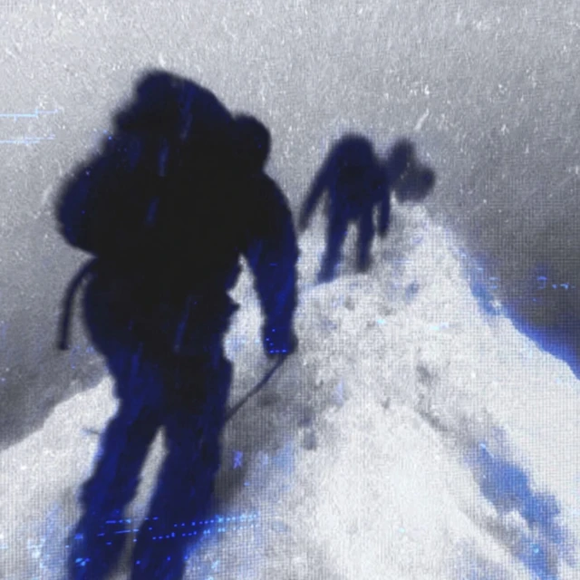 Mountain Climbers Summiting Snowy Peak