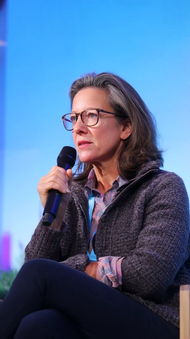 Woman Speaking on Stage at Conference