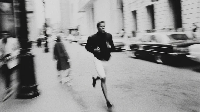 Man Running Down Street Black and White Photography