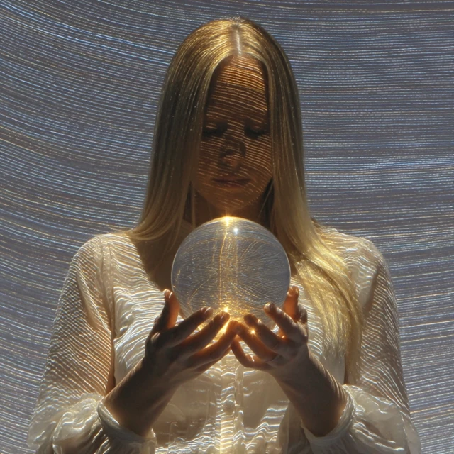 Dreamy Portrait of a Woman Holding Orb of Light