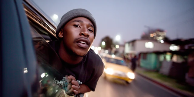 Young Man Leaning Out Car Window at Dusk South Africa