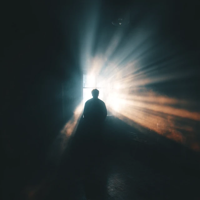 Man in Silhouette with Light Burst