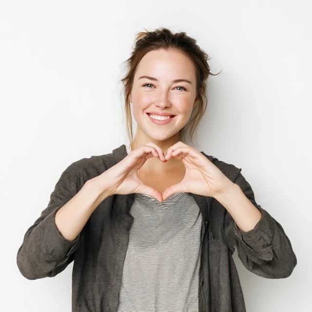 Smiling Woman Makes Heart Sign Photography