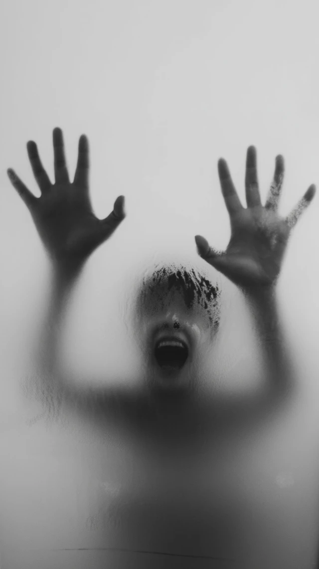 Eerie Scream: Hands Behind Foggy Glass