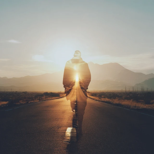 Person Walking on Road: Journey Towards the Light