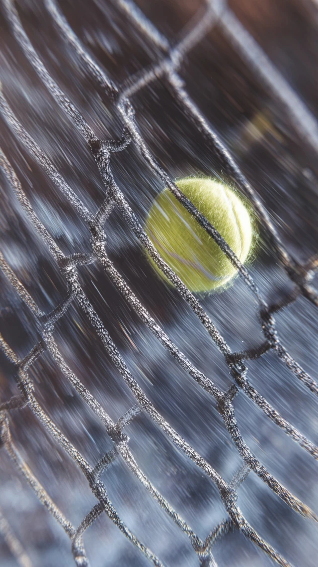 Tennis Ball Through Net Hyperrealistic Shot