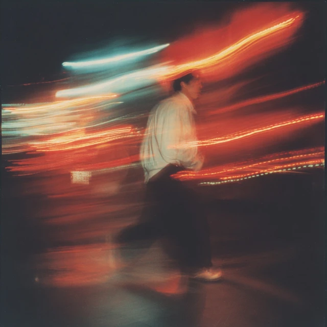 1990s Night Photography Man Walking with Motion Blur