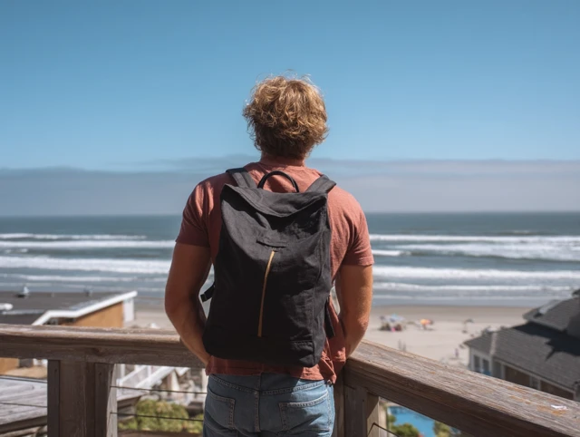 Man on Beach with Backpack Ocean View