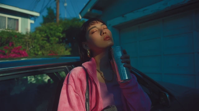 Young Woman Sipping Drink Next to Car