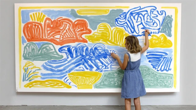 Artistic Girl Drawing on a Wall Painting