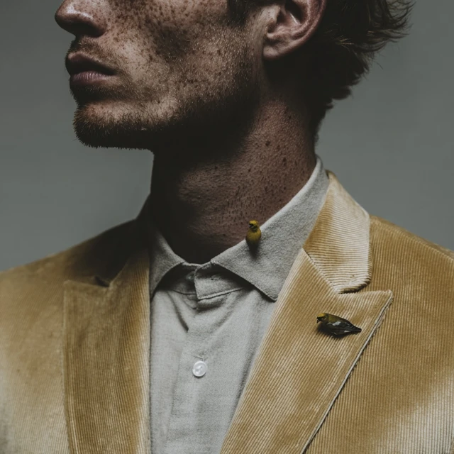Man in Corduroy Suit with Goldfinch on Shoulder