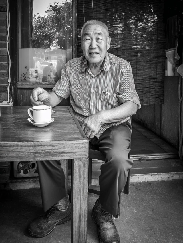 Cute Grandfather Relaxing with Tea