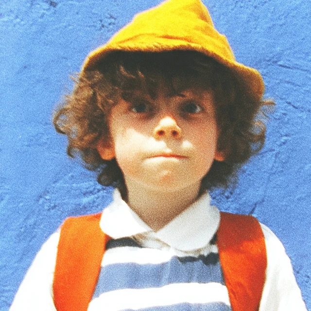 Child in School Uniform with Yellow Hat and Backpack