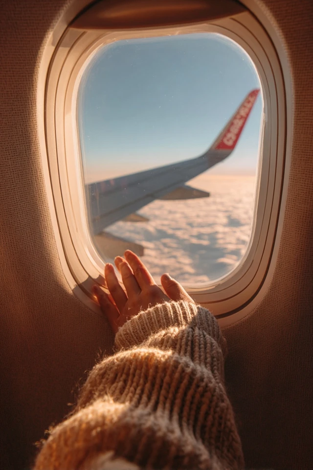 Airplane Window View Golden Hour Hand Clouds