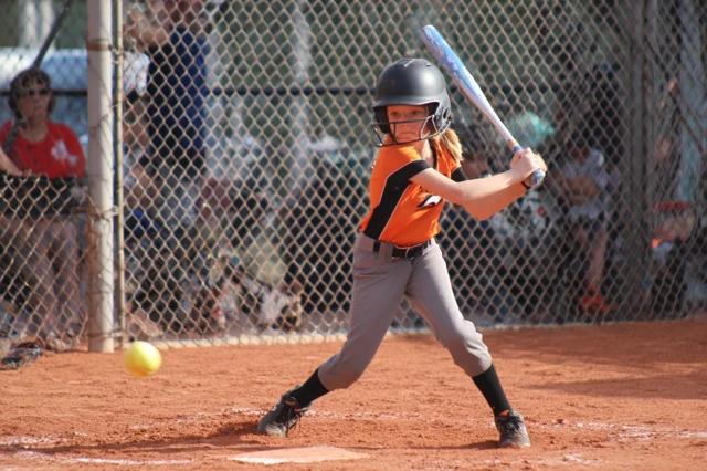 Youth Softball Player in Action Photo