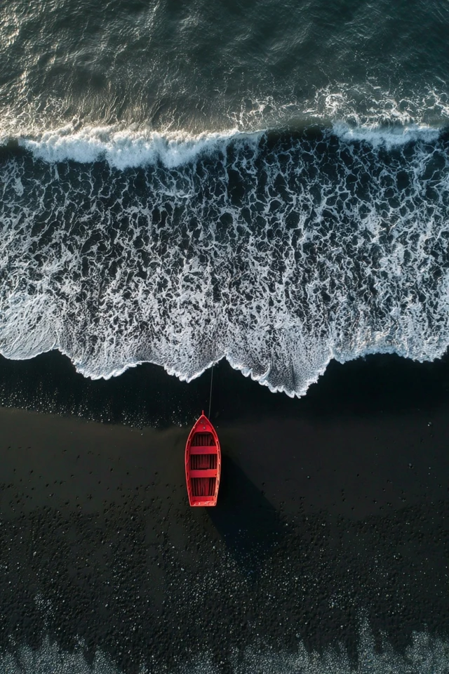 Red Boat on Black Sand Beach in Iceland
