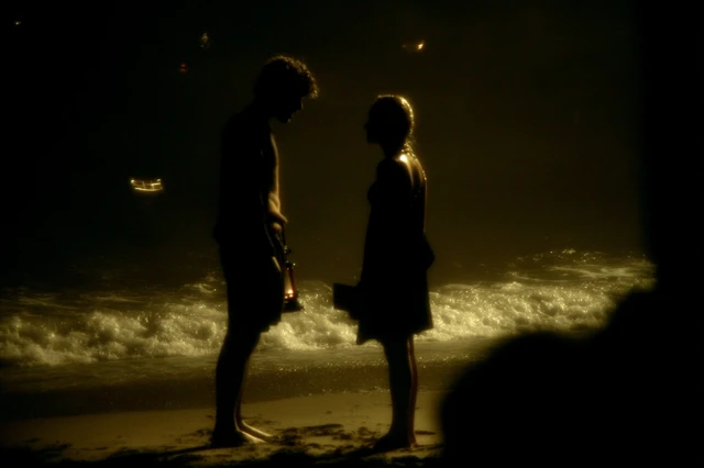 Night Beach Scene with Oil Lamps