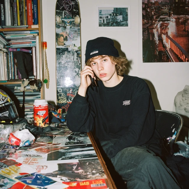 Confused Skater Boy At Home Talking On Phone