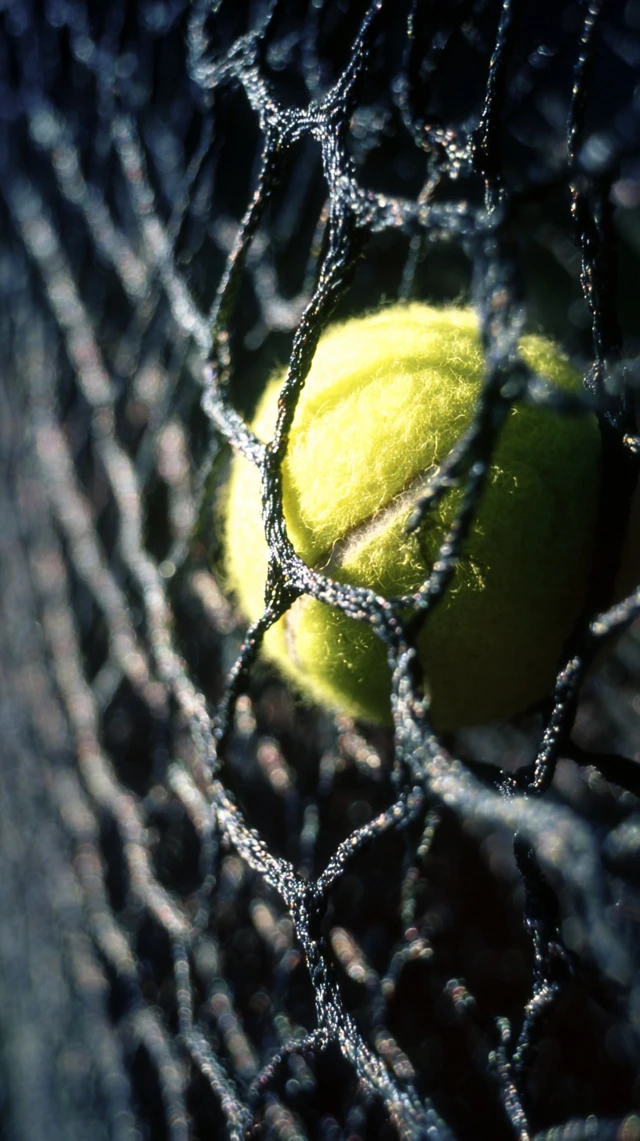 Tennis Ball Through Net Hyperrealistic Shot