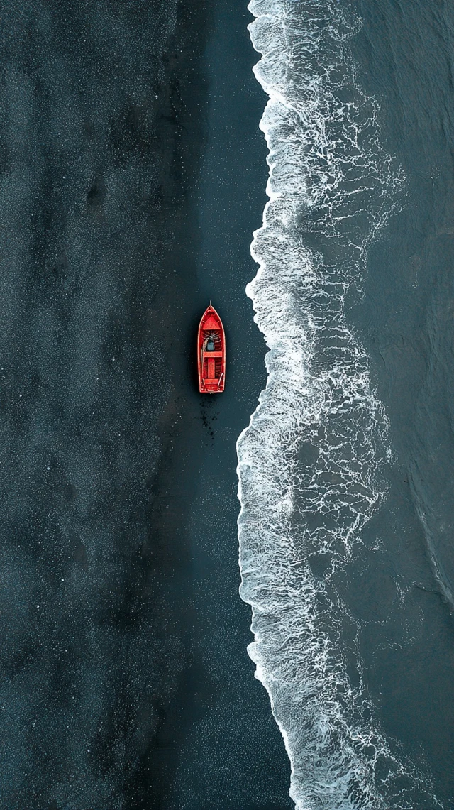 Red Boat on Black Sand Beach Iceland Aerial View