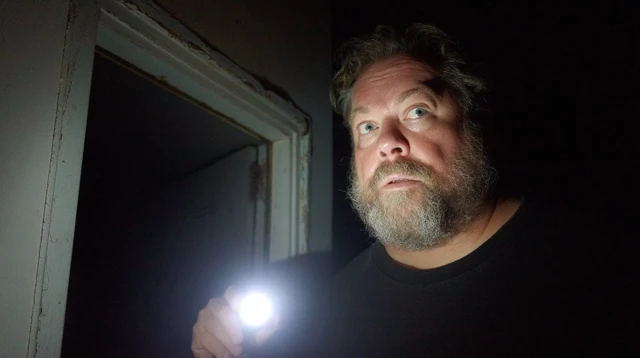 Man with Flashlight Investigating Cellar at Night