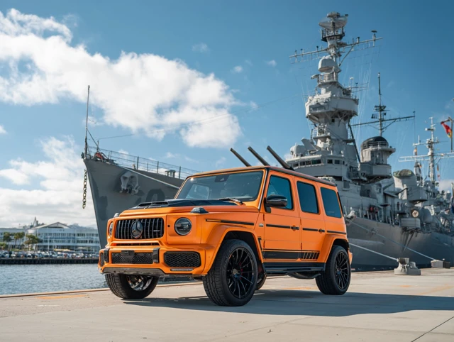 Orange Mercedes Benz G63 AMG 2024 in front of Battleship