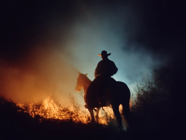 Cowboy Silhouette Riding Horse at Night Photograph